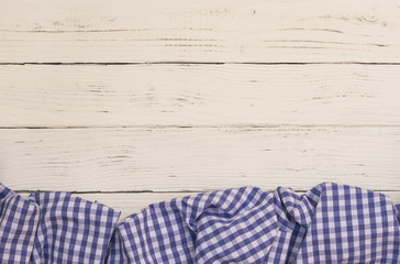 Checkered tablecloth on white wooden table