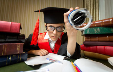 girl in graduation cap putting stamp on document