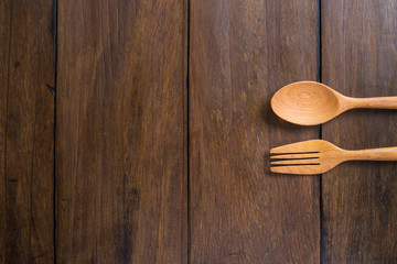 spoons, forks on wooden background