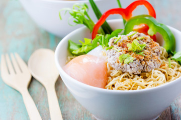 Chinese noodles with minced pork and egg in bowl