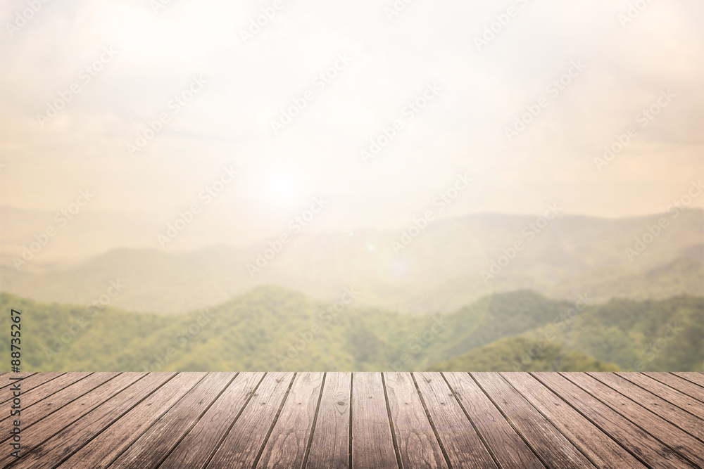 Wall mural wooden floor with mountain landscape blurred background