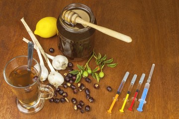 Rosehip tea and flu vaccination. Traditional medicine and modern treatment methods. Injection of influenza vaccine. Household treatment of flu and colds.
