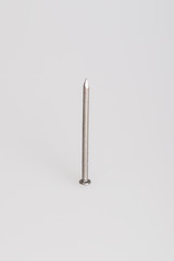 Single steel nail shot against a white background