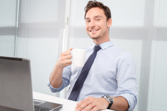 Smiling call center operator drinking tea 