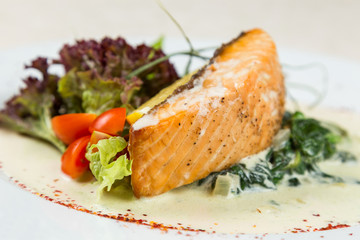 salmon steak with vegetables serving in restaurant