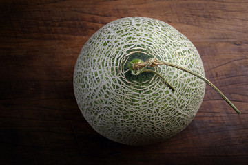 Fresh organic Japanese melon on wooden table