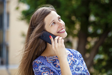 Happy beautiful girl calling by phone
