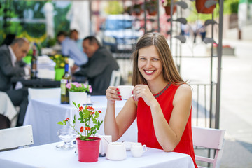 Beautiful brunette girl sitting in a coffee shop