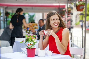 Beautiful brunette girl sitting in a coffee shop