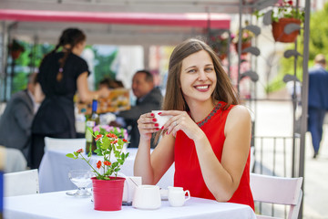 Beautiful brunette girl sitting in a coffee shop