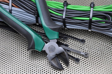 Electrical tools and cables on metal surface
