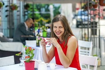 Beautiful brunette girl sitting in a coffee shop