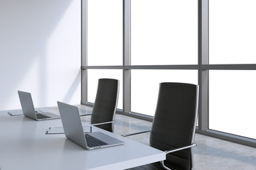 Modern meeting room with huge windows with copy space. Black leather chairs and a white table with laptops. 3D rendering.