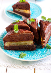 Fototapeta na wymiar Chocolate and mint cake with pear filling