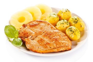 Fried chicken fillets, boiled potatoes and pineapples