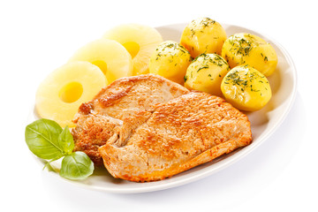 Fried chicken fillets, boiled potatoes and pineapples
