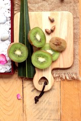 Kiwi fruit juicy green on wood background.