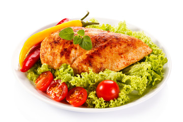 Roast chicken fillet and vegetables on white background 