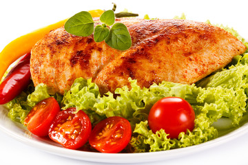 Roast chicken fillet and vegetables on white background 