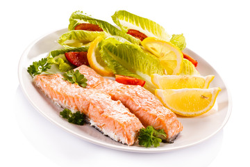 Roasted salmon and vegetables on white background