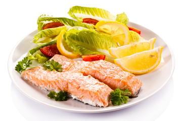 Roasted salmon and vegetables on white background