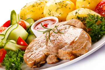 Fried steak, boiled potatoes and vegetable salad 
