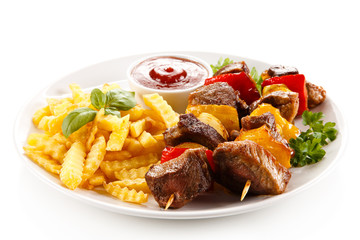 Grilled meat, French fries and vegetables 
