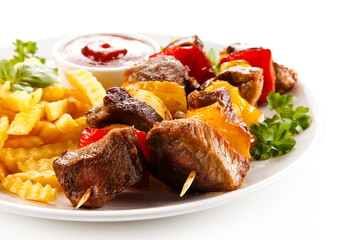 Grilled meat, French fries and vegetables 