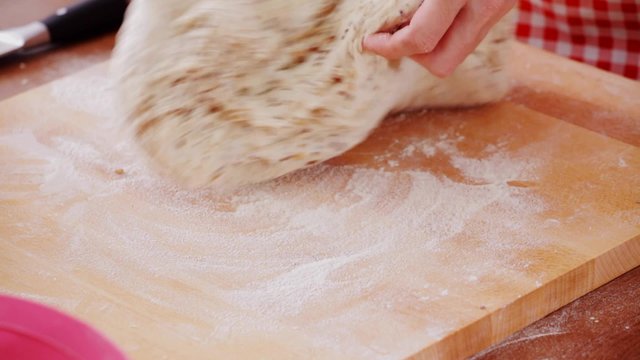 HD 1080 close up: home cooking - kneeding bread dough at working board; 