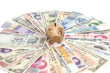 Golden piggy bank with International currencies