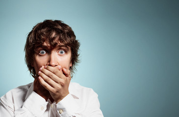 Closeup portrait of handsome young shocked business man, silent