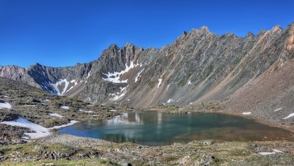 Naklejka na ściany i meble Beautiful lake at the foot of the mountain range