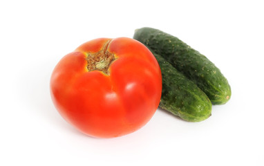 Tomato and two cucumber on white background