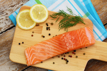 Raw salmon fillet on wooden board
