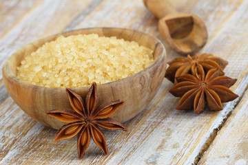 Brown sugar in wooden bowl and star anise
