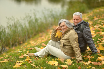 Naklejka na ściany i meble Senior couple near lake