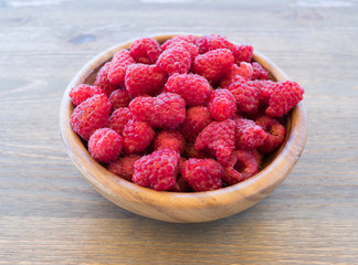 Fresh organic fruit - raspberry on wood background selective focus
