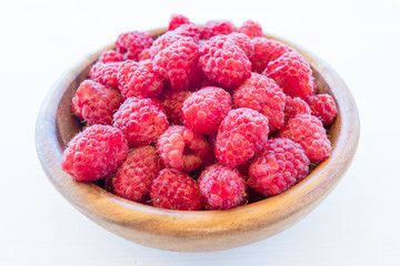 Fresh organic fruit - raspberry on wood background selective focus