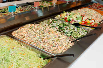 Various salads in gastronomical containers