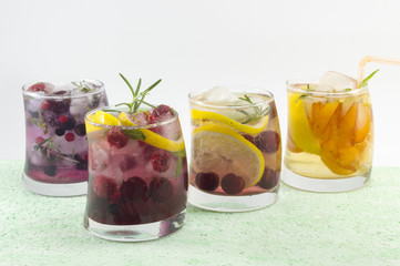Four non alcoholic fruit cocktails arranged on the green table w