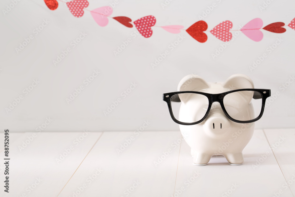 Wall mural piggy bank wearing black glasses