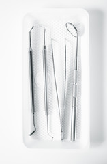 Metal dental medical equipment tools on tray