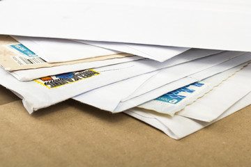 a pile of letters and postal parcel
