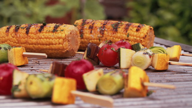 Vegetable kebabs, corn, asparagus, vine tomatoes grilling on a barbecue