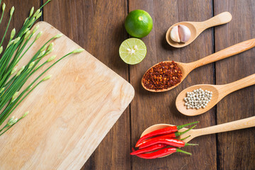 Red chilli, garlic and lemon on wooden background