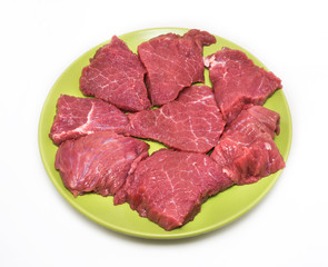 Appetizing pieces of beef on green plate