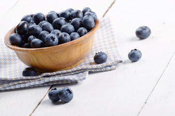 Wooden bowl with organic blueberries