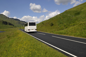 White bus on mountain road