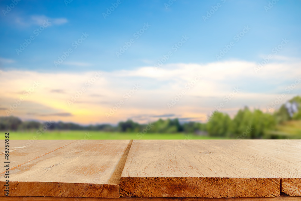 Poster empty table and field of grass and perfect sky background