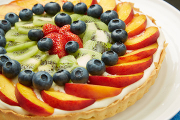 Fresh Fruits on Top of Tasty Cake with Frosting